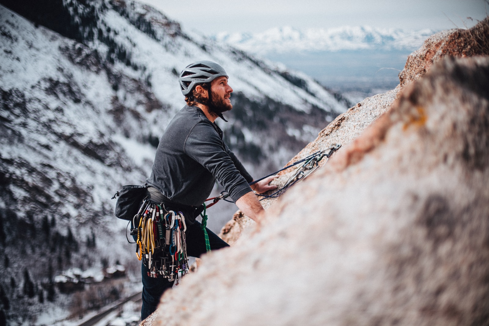 man in black jacket climbing mountain during daytime